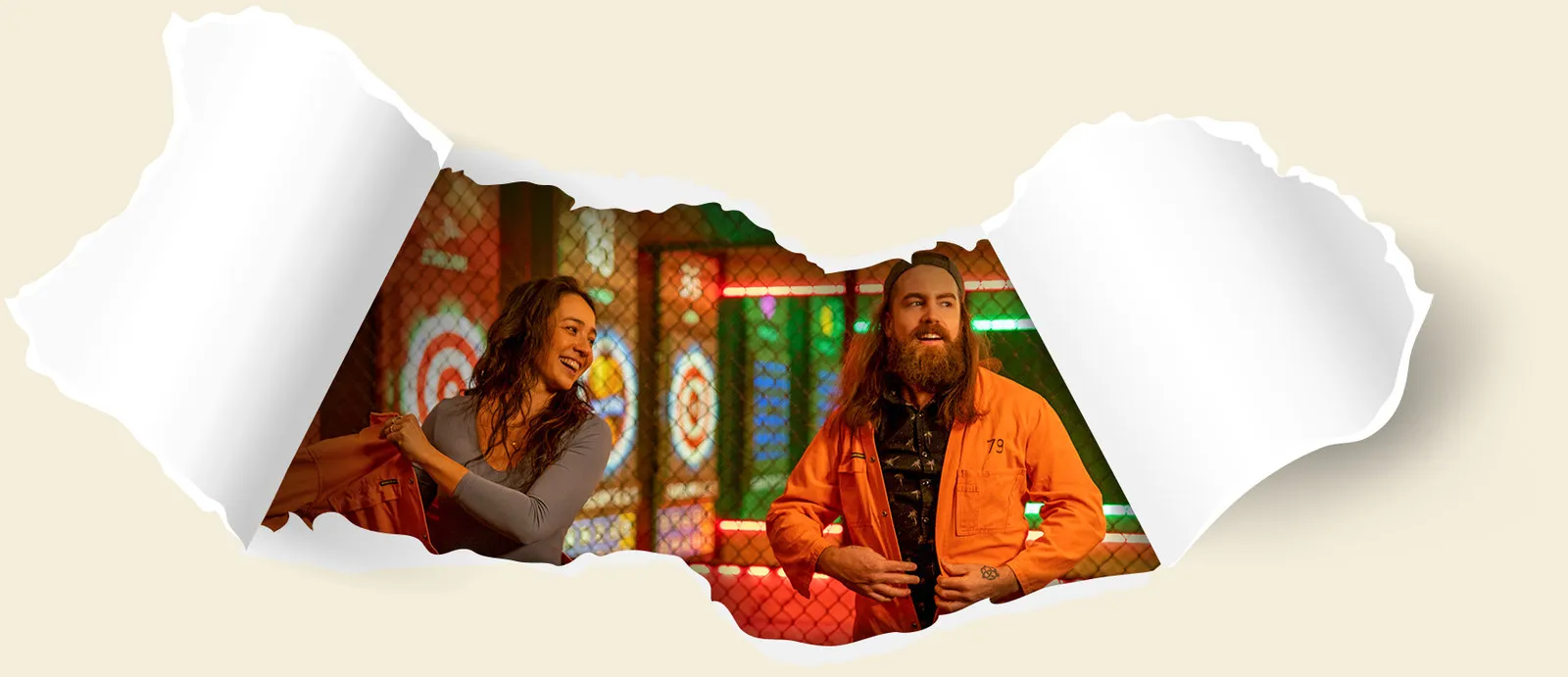 Couple laughing in orange smash room overalls