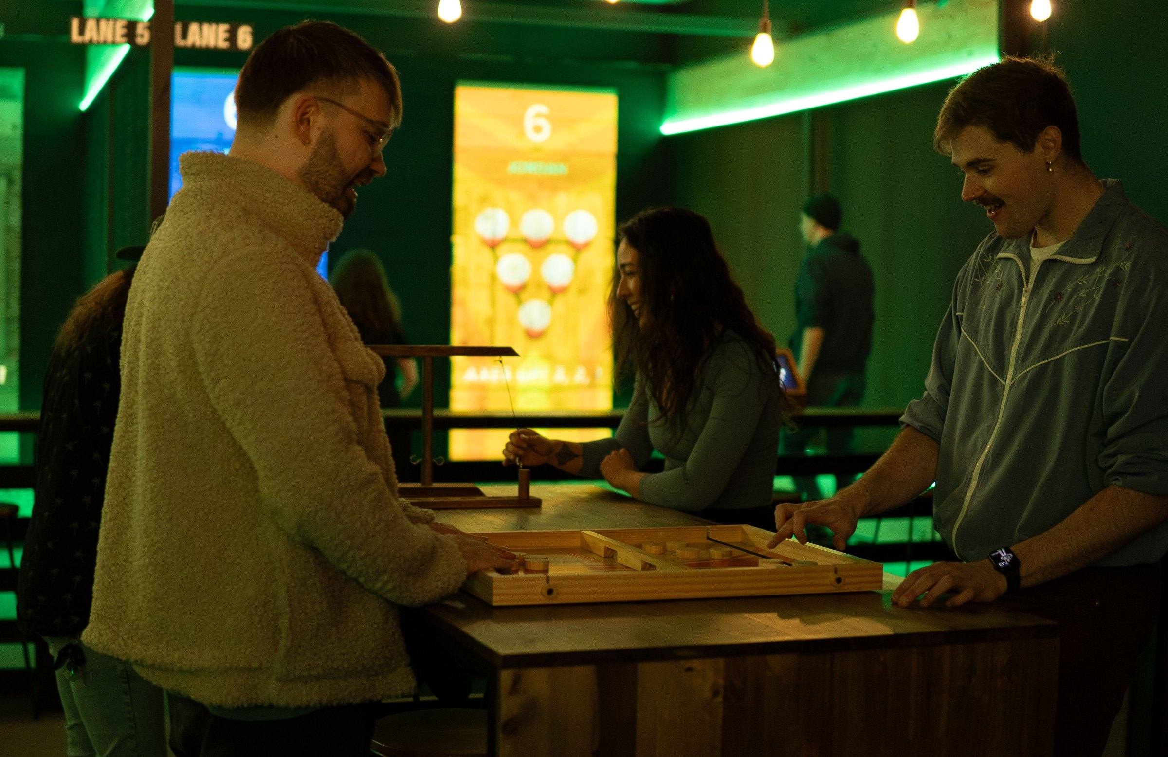 Group playing a table game between rounds at Axxe