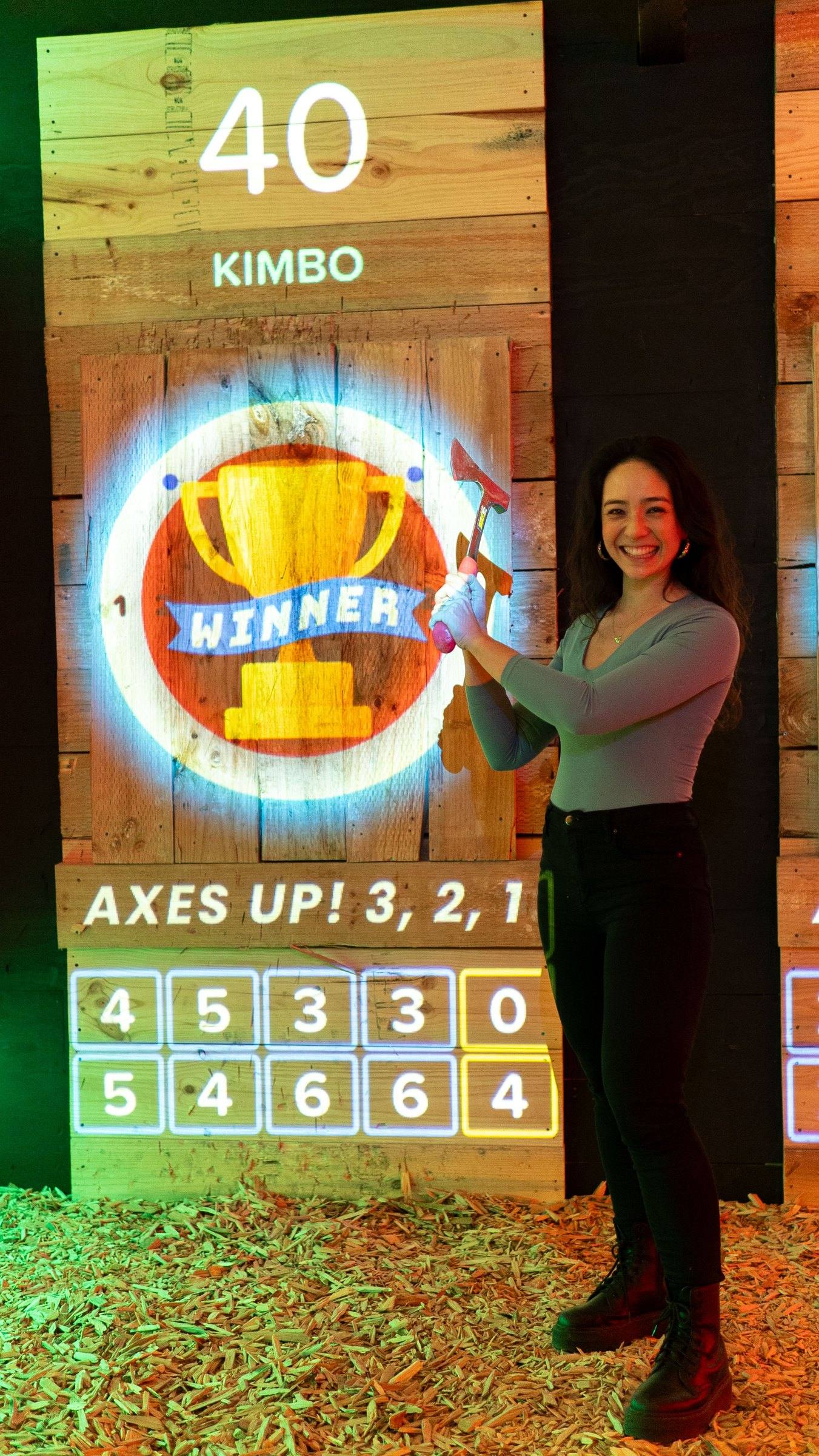 Smiling woman next to a digital target showing a winner trophy